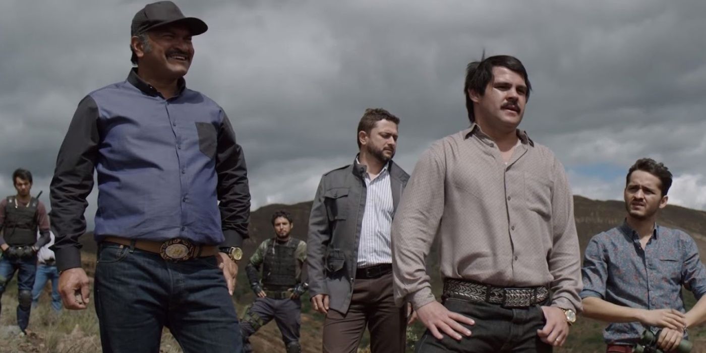 Marco de la O as El Chapo standing on a hill surrounded by other men in his gang