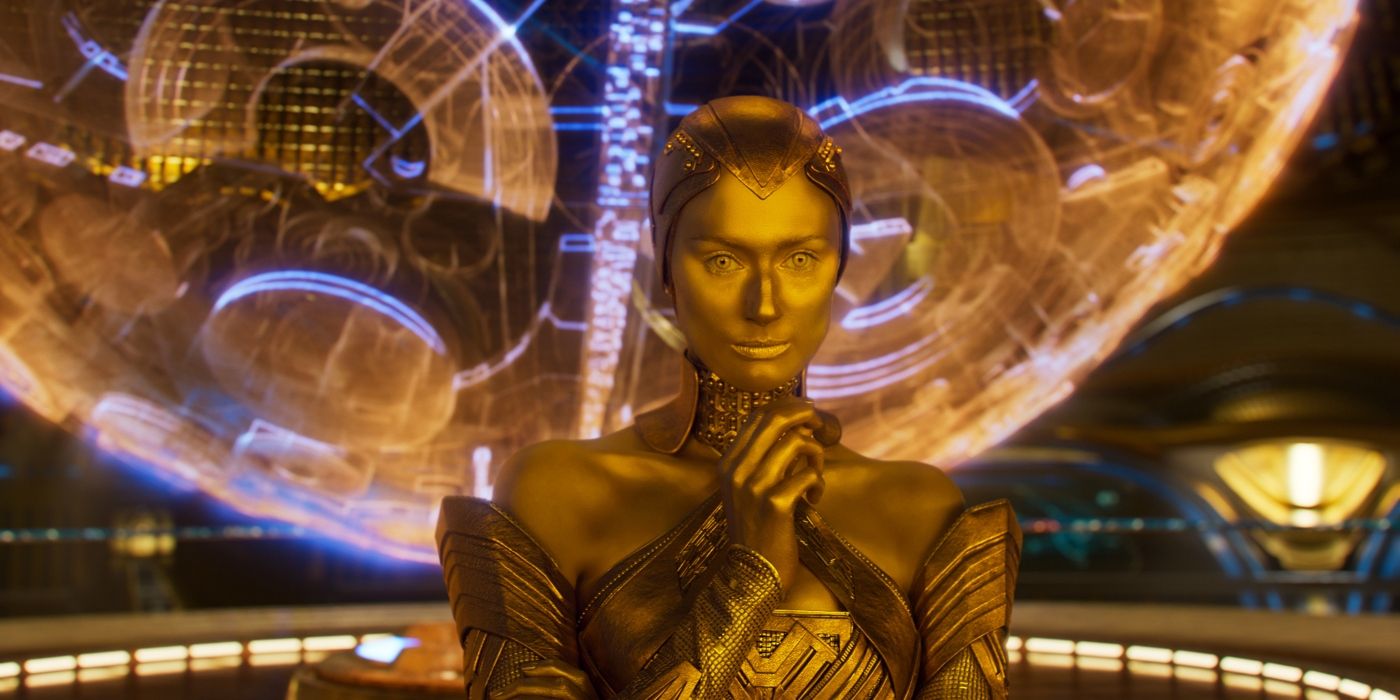 Elizabeth Debicki in gold paint, clasping her hands as Ayesha in Guardians of the Galaxy Vol. 3