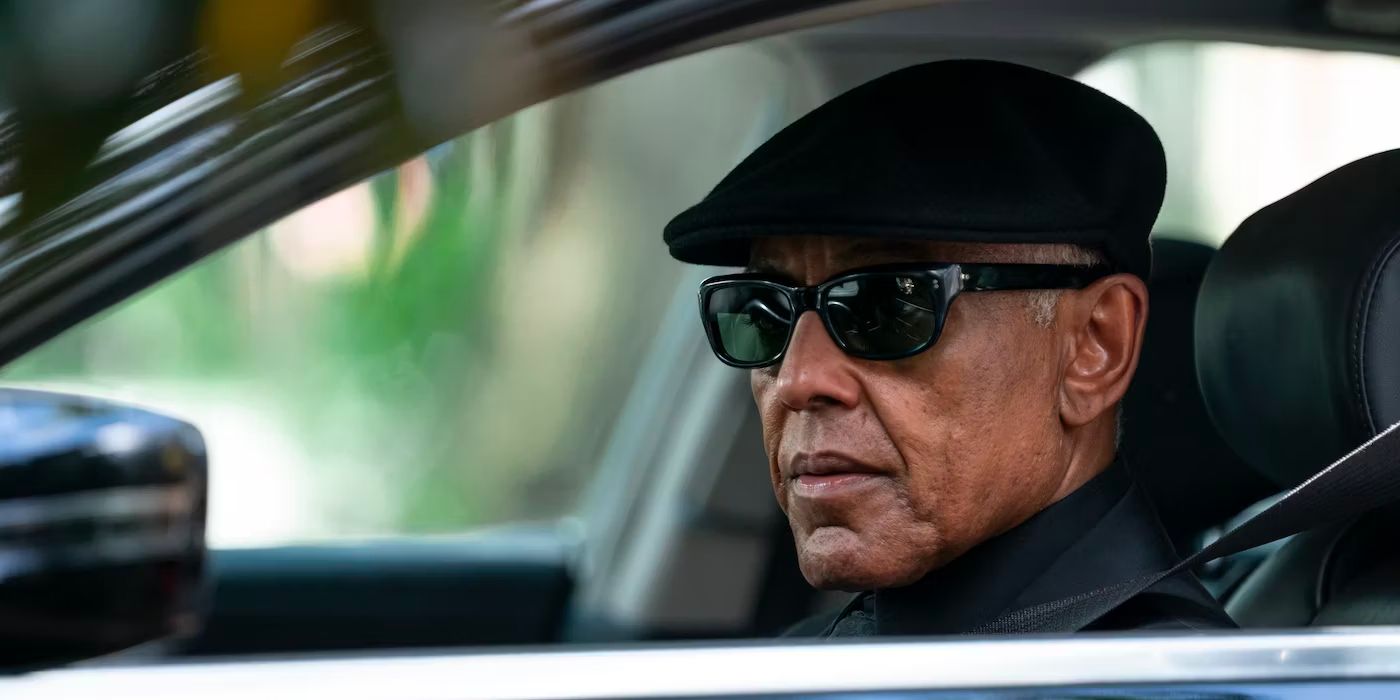 Giancarlo Esposito in sunglasses and a cap, in a car, looking out, in Parish (2024) AMC