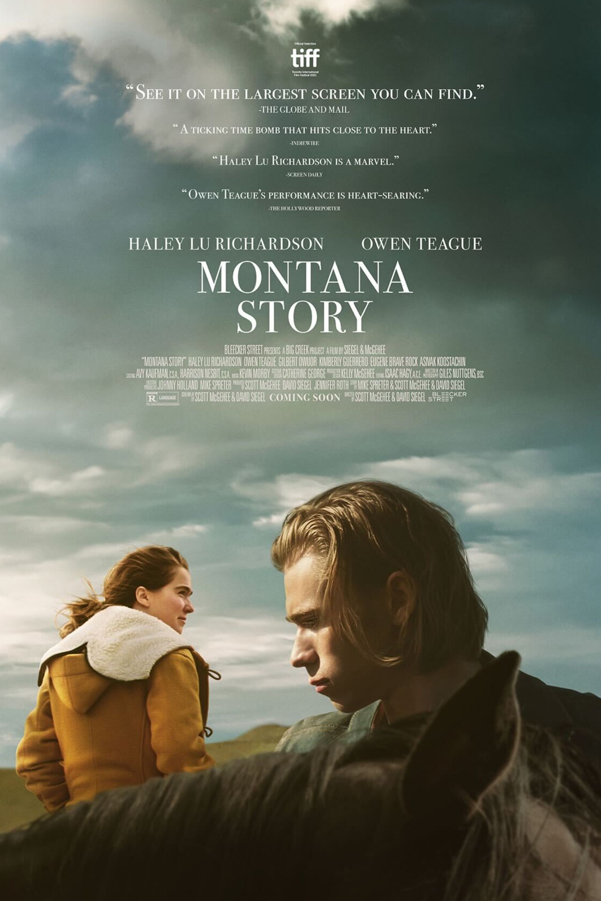 Owen Teague as Cal and Haley Lu Richardson as Erin standing in a field in Montana in Montana Story