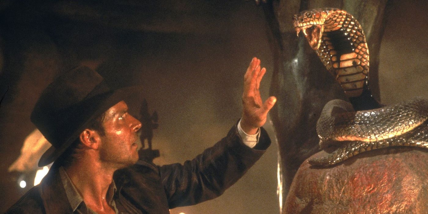 Indiana Jones reaching for a snake statue in Temple of Doom