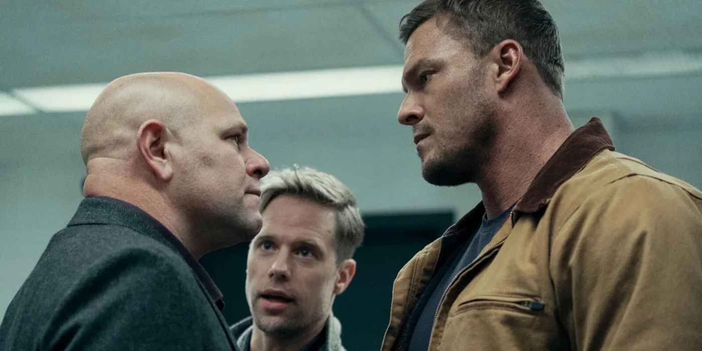 Alan Ritchson as Jack Reacher next to Shaun Sipos as David O'Donnell talking to another man in Reacher
