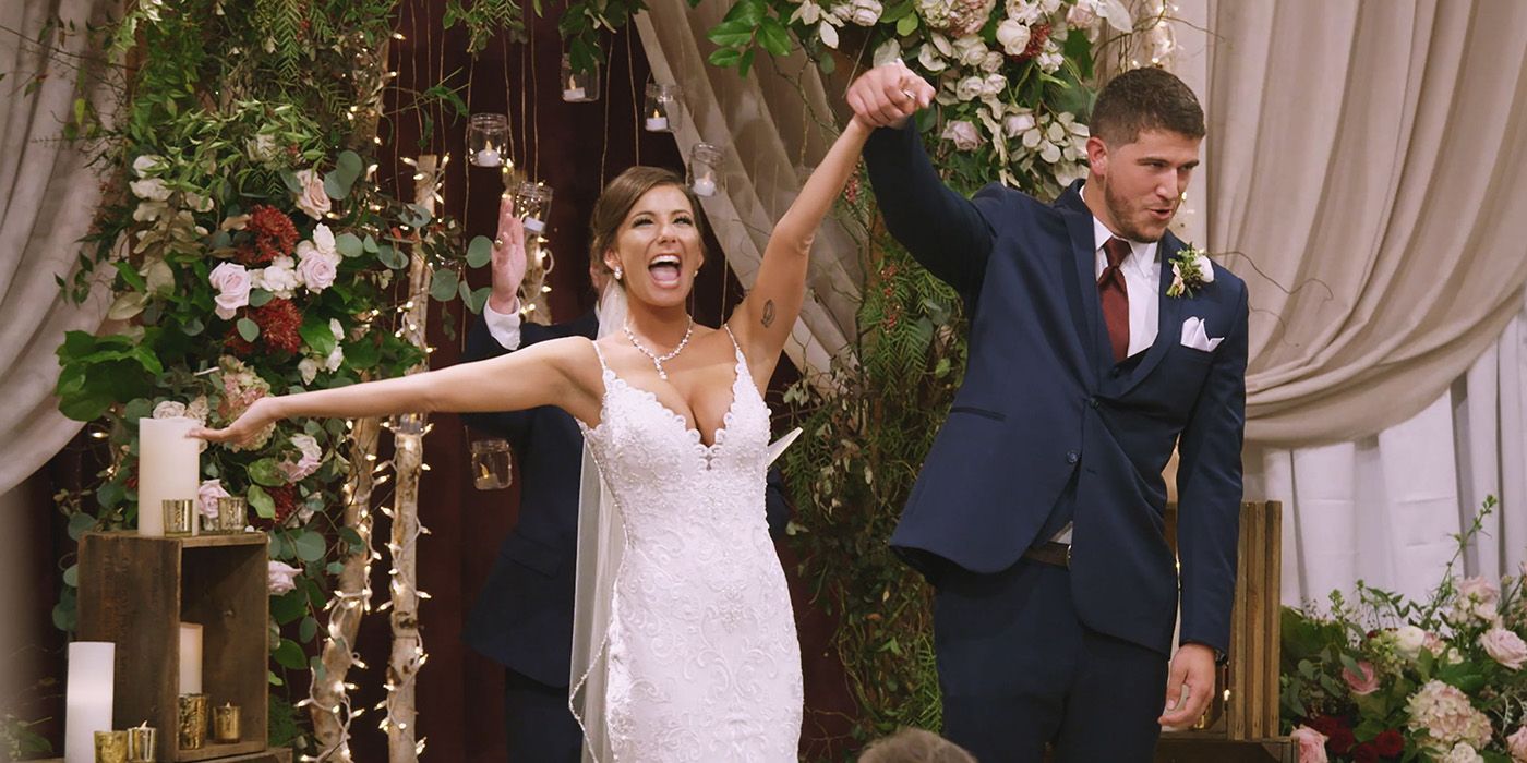 Amber and Barnett cheering as they walk down the aisle together on Love is Blind.