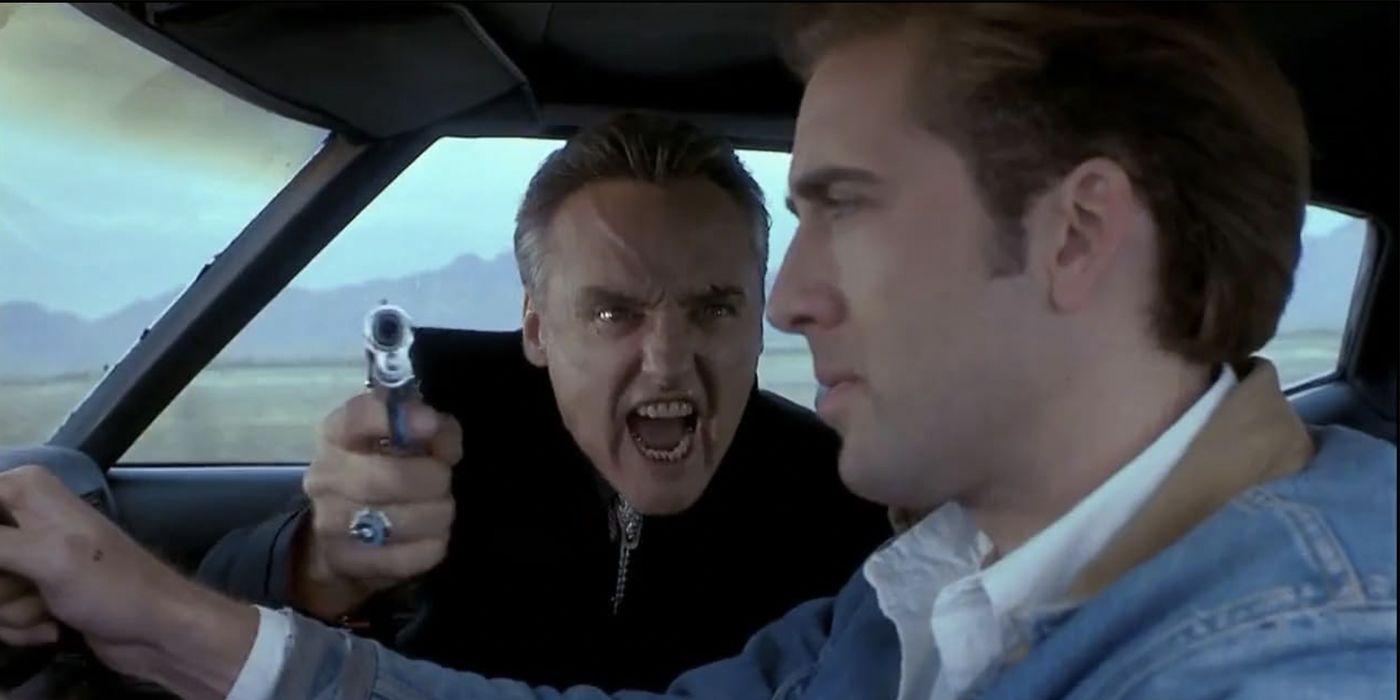 Dennis Hopper as Lyle, from Dalals pointing a gun at Nicolas Cage as Michael while he drives in Red Rock West