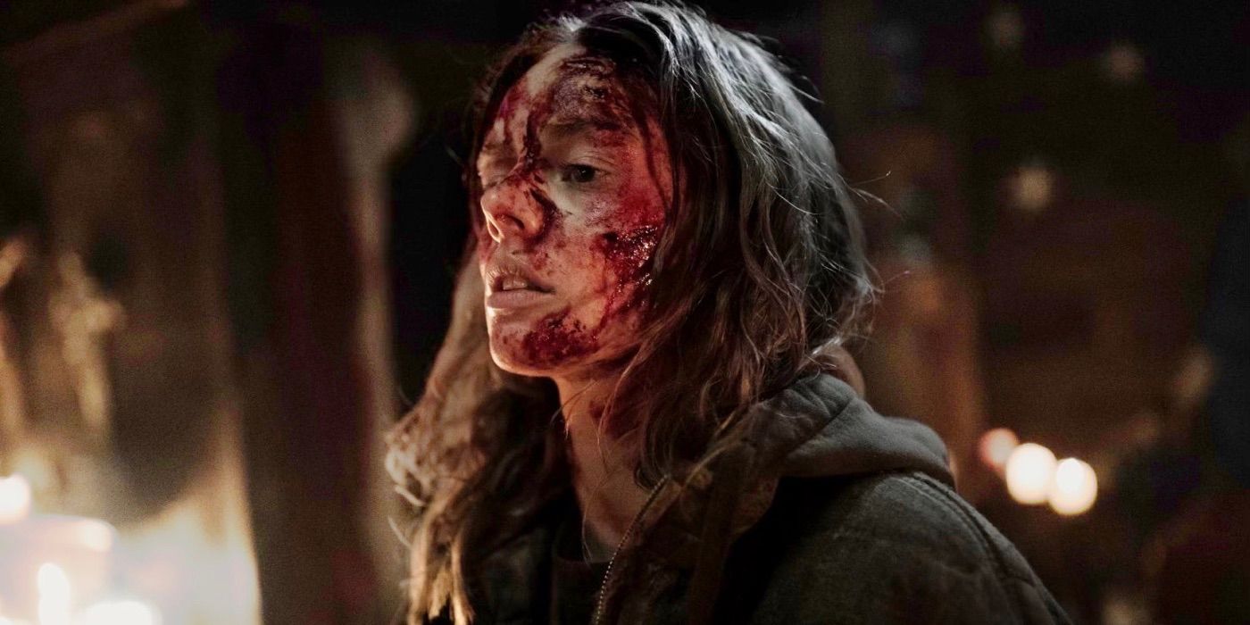 Samara Weaving as Azrael with blood all over her face wearing a dark jacket in Azrael