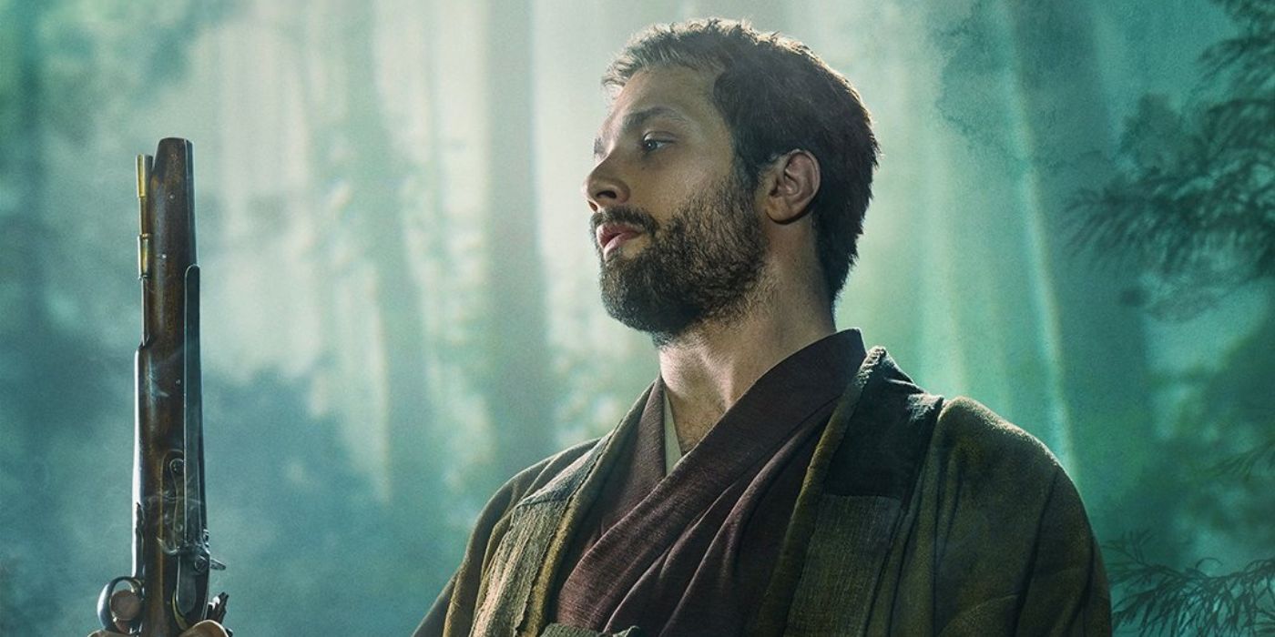 Cosmo Jarvis as John Blackthorne wearing robes holding a musket pistol standing in the forest in Shogun