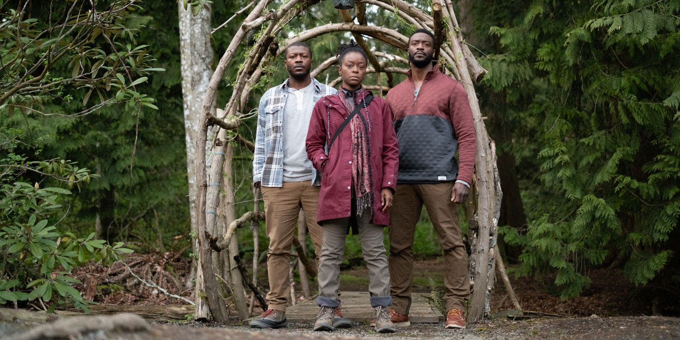Aldis Hodge as Alex, Edwin Hodge as Martel, and Danielle Deadwyler as Vanessa standing in the woods in Parallel