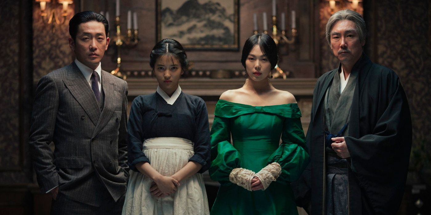 The cast of The Handmaiden standing in what appears to be a lavish, dark brown manor (2016)