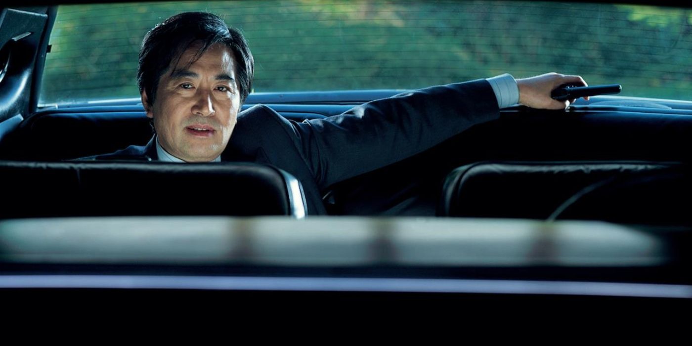 Han Suk-kyu as KCIA Chief Agent Kim Jae-kyu, sitting in the back of a government car