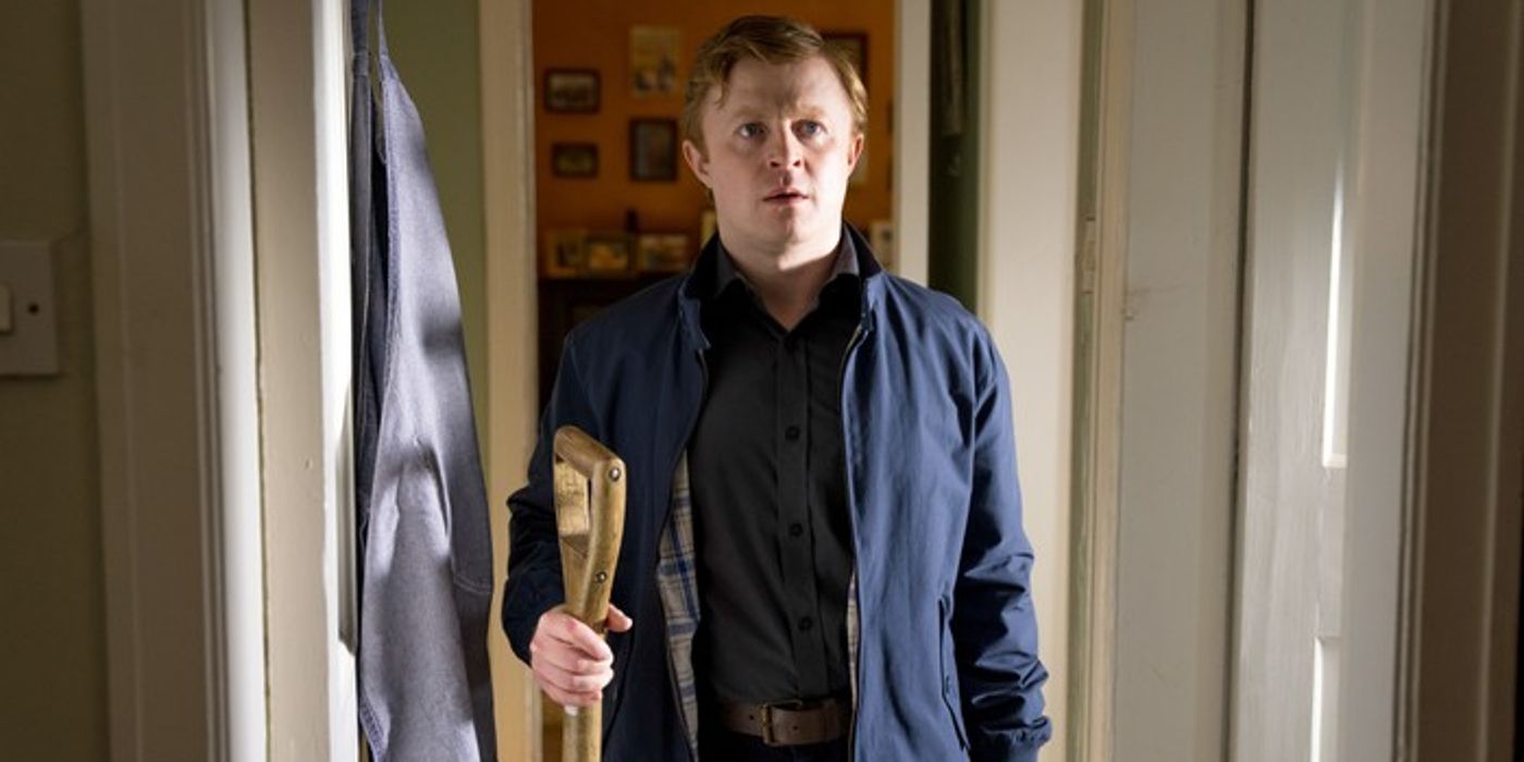 Conor MacNeill as Ruairi Slater holding a shovel while wearing a dark jacket in The Tourist
