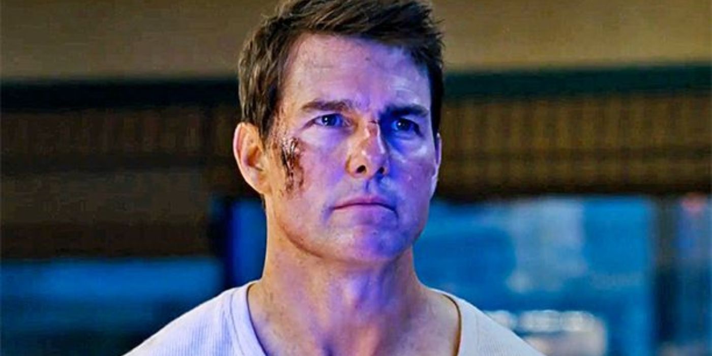Tom Cruise as Jack Reacher with blood on his face looking at someone off-screen in Jack Reacher: Never Go Back