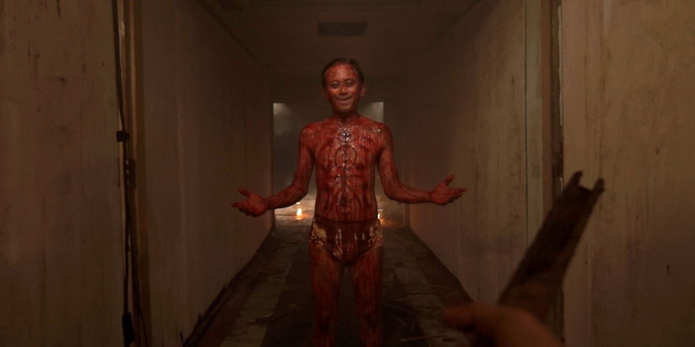a first person perspective of a blood-stained man in his underwear in the film V/H/S/2