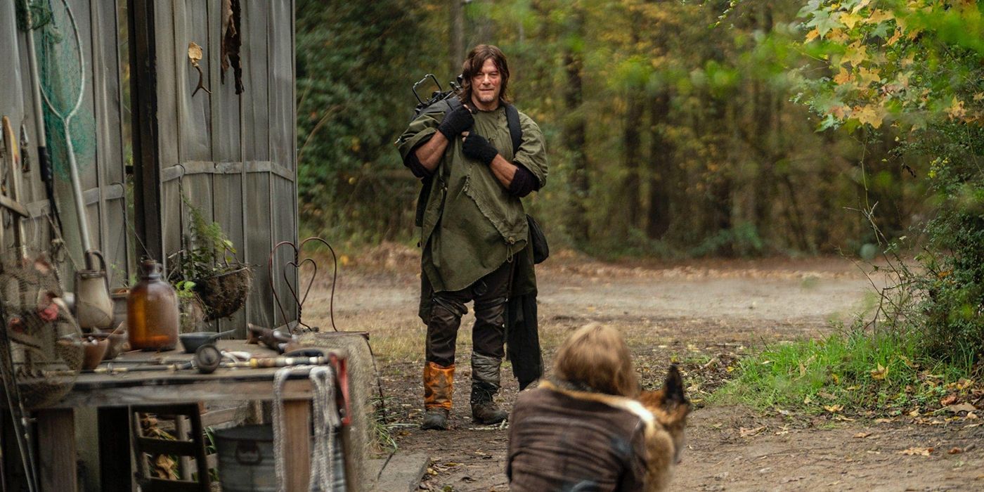 Norman Reedus as Daryl with his crossbow standing in front of Leah and Dog facing him in The Walking Dead.