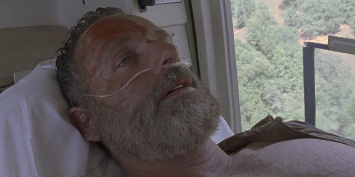 Andrew Lincoln as Rick with oxygen on his nose lying down in a helicopter from The Walking Dead.