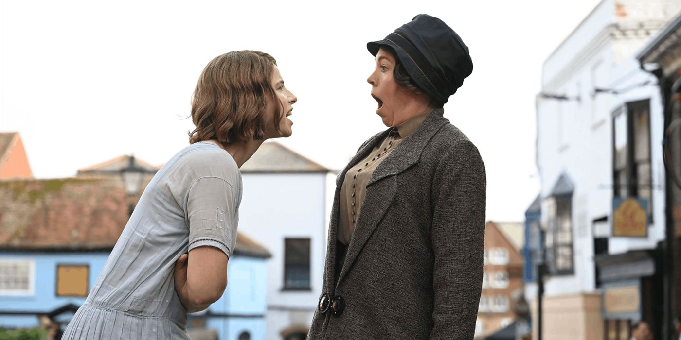 Jessie Buckley as Rose with Olivia Colman as Edith Swan wearing a dark jacket and hat in Wicked Little Letters
