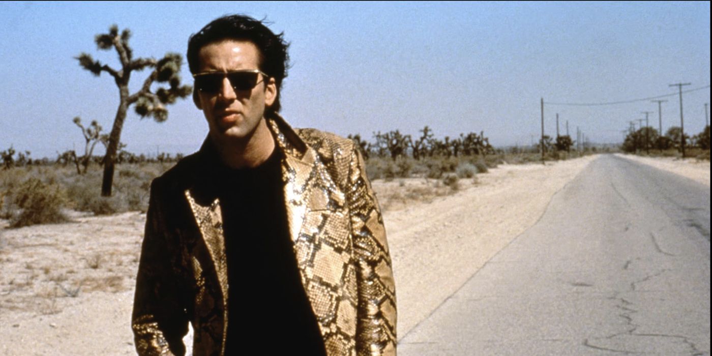 Nicolas Cage as Sailor walking on the side of the road in Wild at Heart