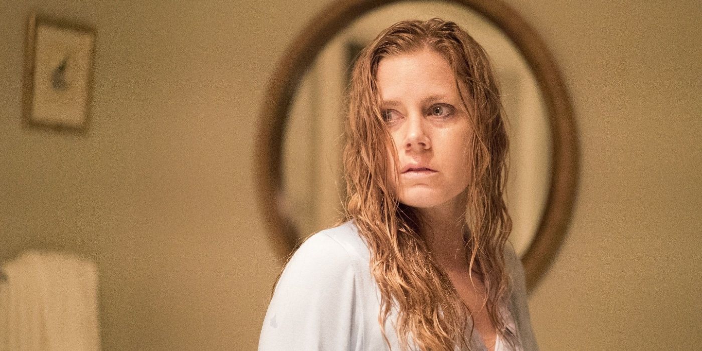 Amy Adams, in a bathroom with wet hair, staring inquisitively, in The Woman In the Window (3)