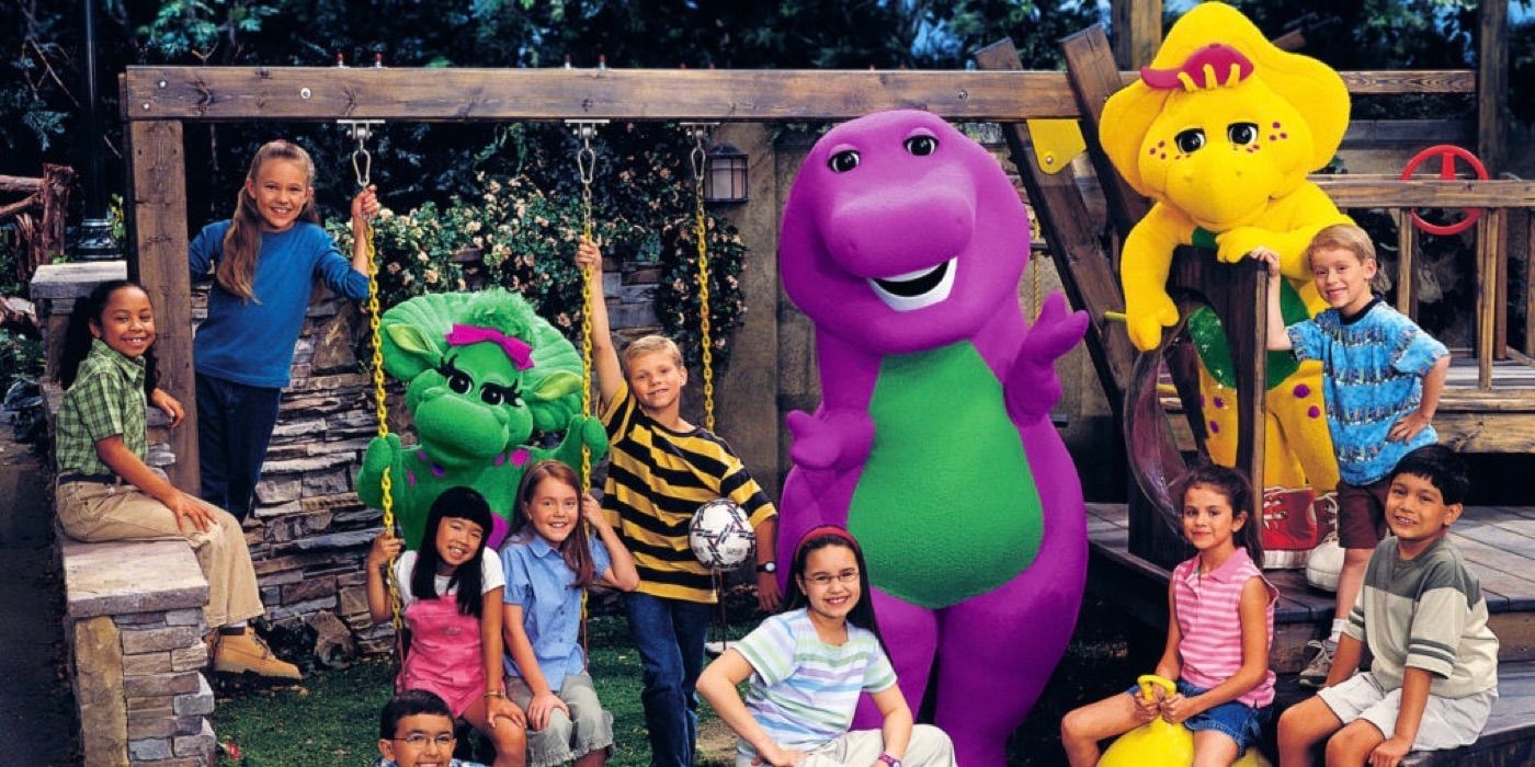 The entire cast of Barney and Friends at a playground smiling in Barney and Friends