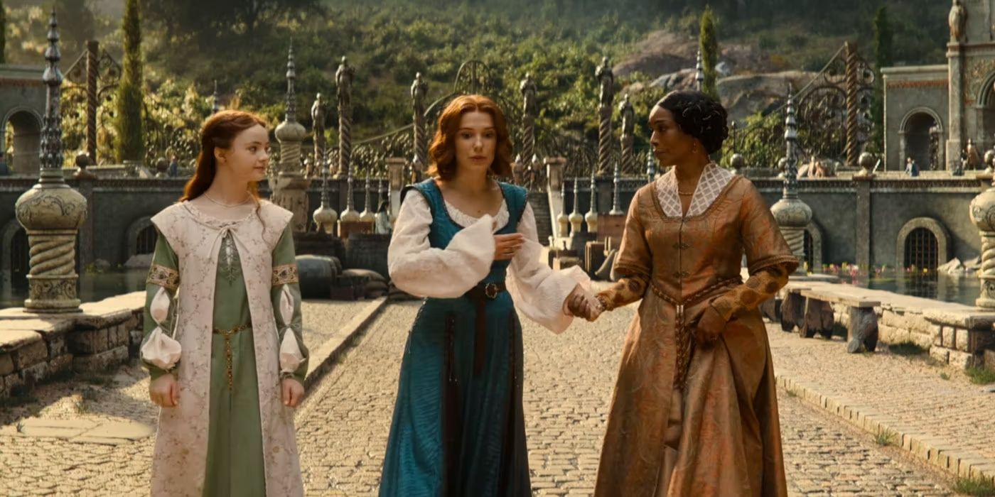 Elodie with her mother and sister walking on a cobblestone street at the end of Damsel