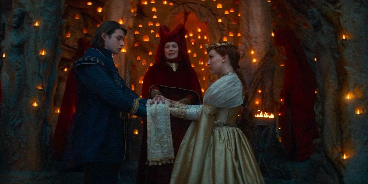 Prince Henry and Elodie at the wedding ceremony in the mountains holding each others hands in Damsel