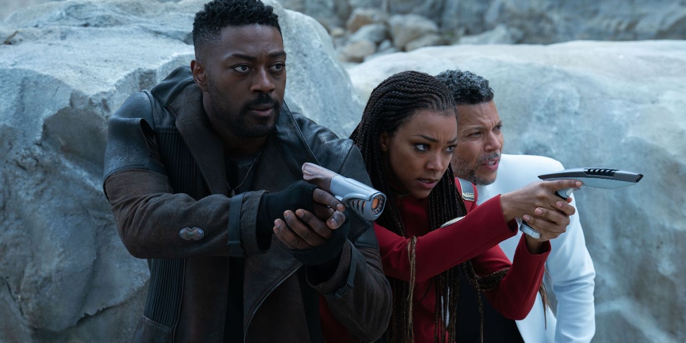 Sonequa Martin-Green, David Ajala, and Wilson Cruz holding small weapons on an ice planet in Star Trek: Discovery