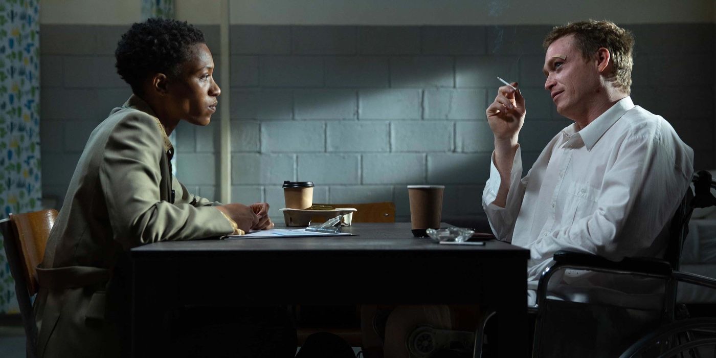 Jonnica T. Gibbs as Evelyn and Caleb Landry Jones as Douglas being interrogated while smoking a cigarette in Dogman