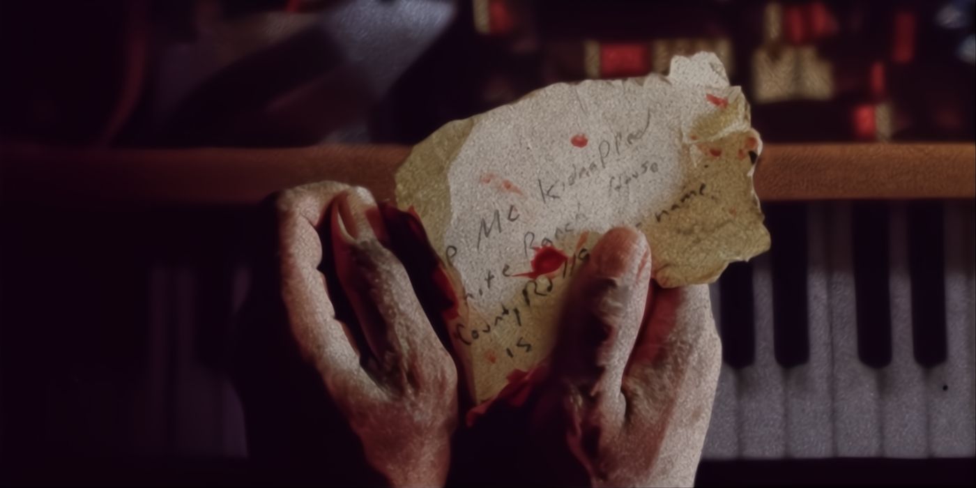 Hands hold a letter in Dead Mail poster