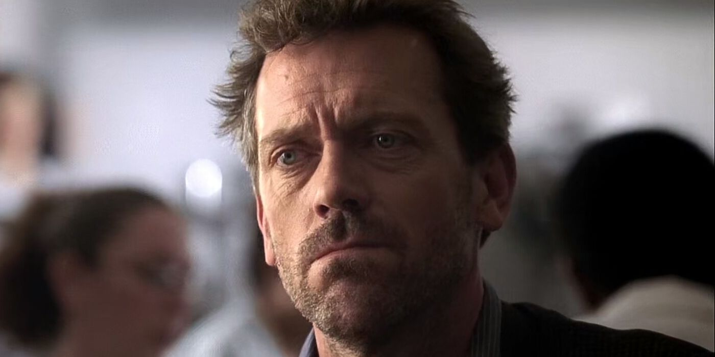 Hugh Laurie in a candid moment revealing a thoughtful grumpy expression