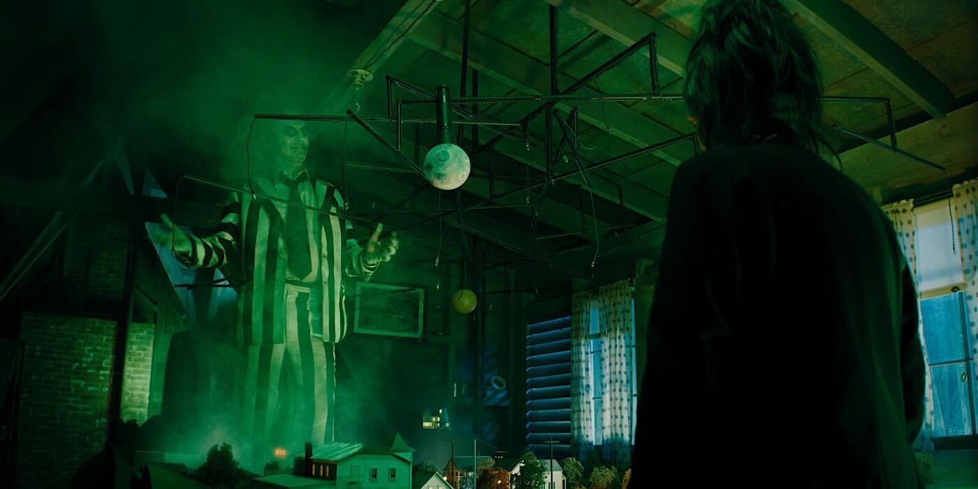 Michael Keaton with hands out standing on a model village as Beetlejuice in new sequel