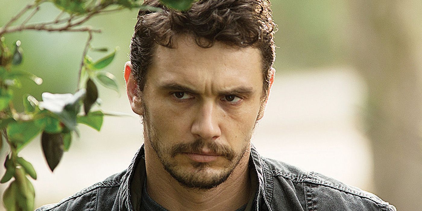 James Franco wearing a dark jean jacket looking off-screen in Rise of the Planet of the Apes
