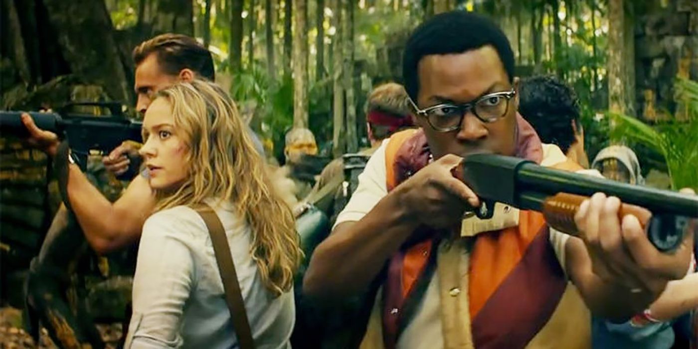 Corey Hawkins holding a rifle, others doing the same on the other side, in a scene from Kong: Skull Island.