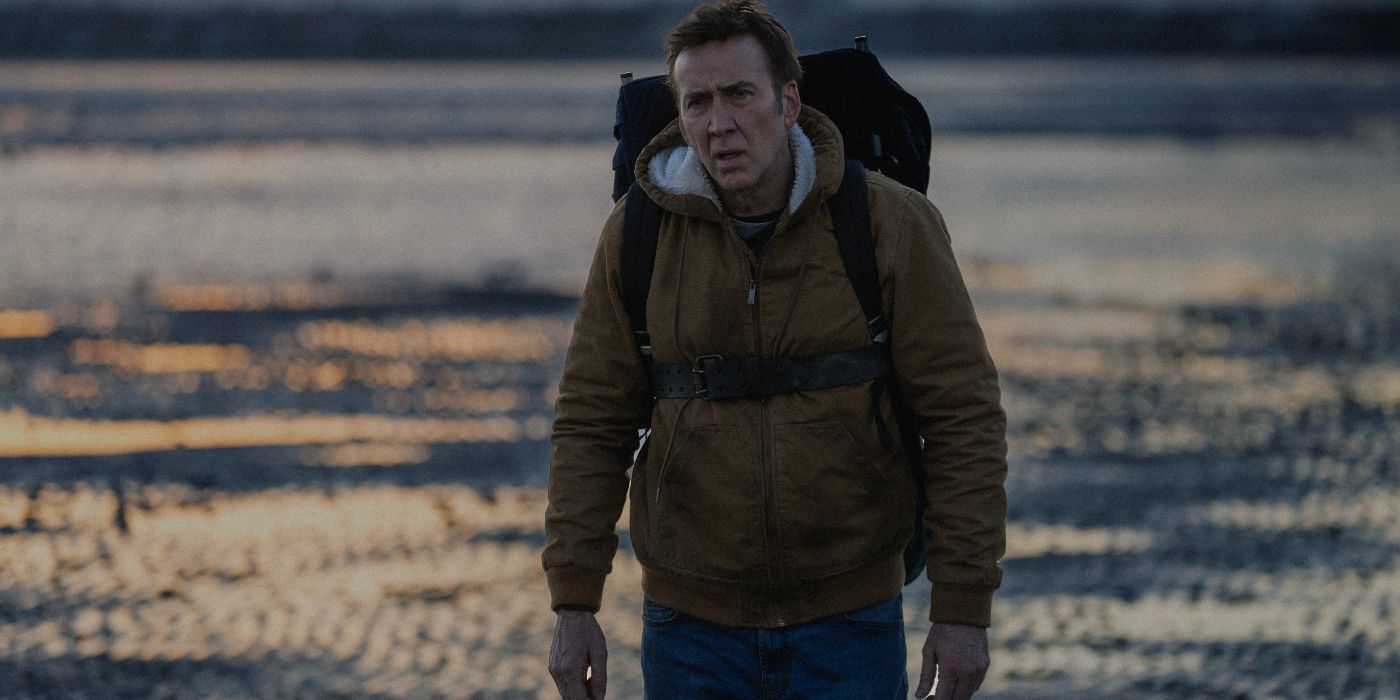Nicolas Cage with a backpack in the lake in Arcadian movie 2024