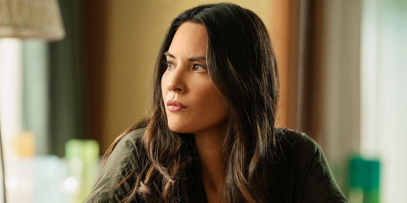 Olivia Munn looking out a window in The Rook.