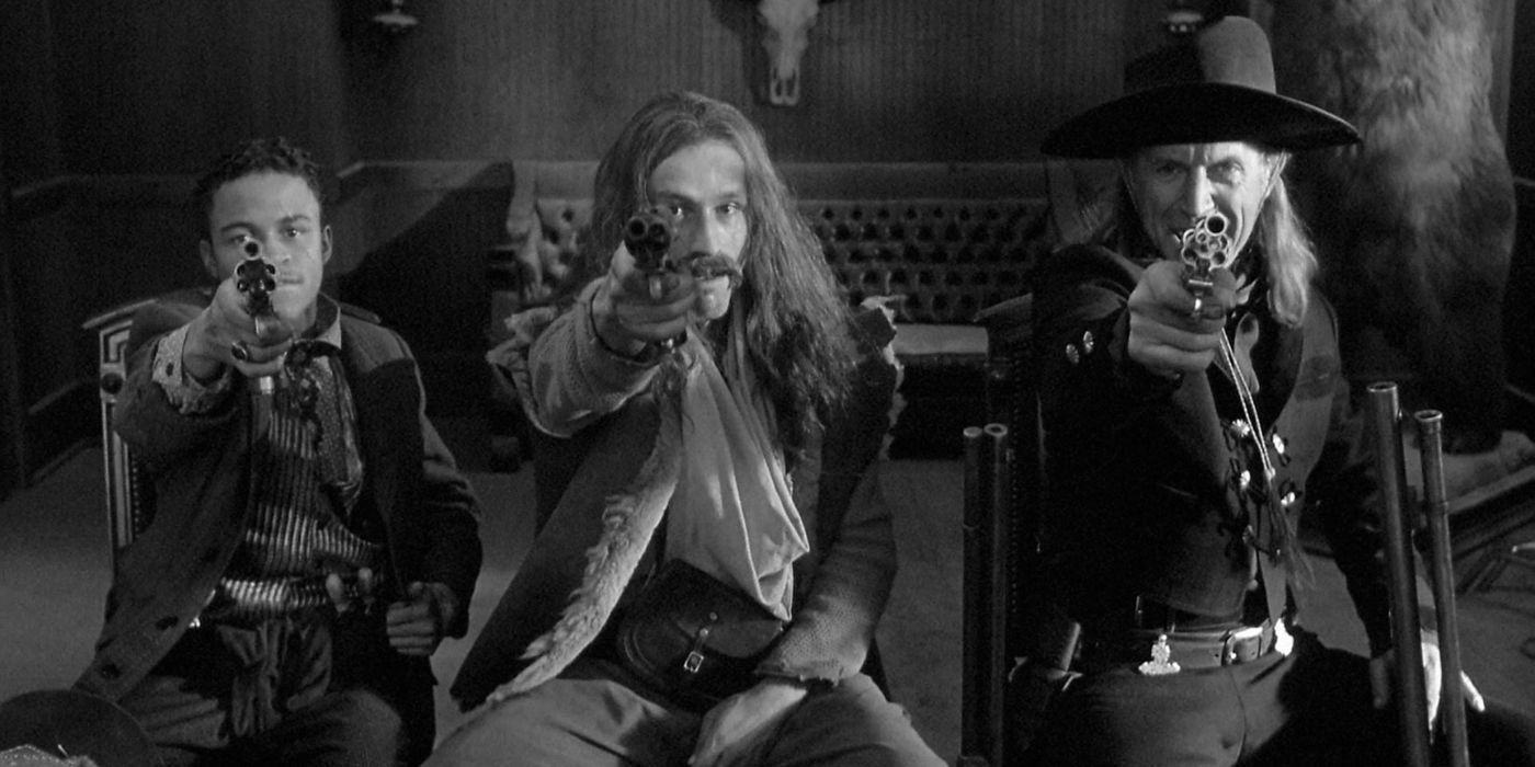 Lance Henriksen as Cole Wilson, Michael Wincott as Conway Twill, and Eugene Byrd as Johnny Pickett pointing guns at the camera in Dead Man (1995)