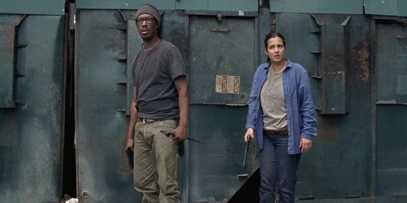 Heath standing by storage units with Tara on The Walking Dead.