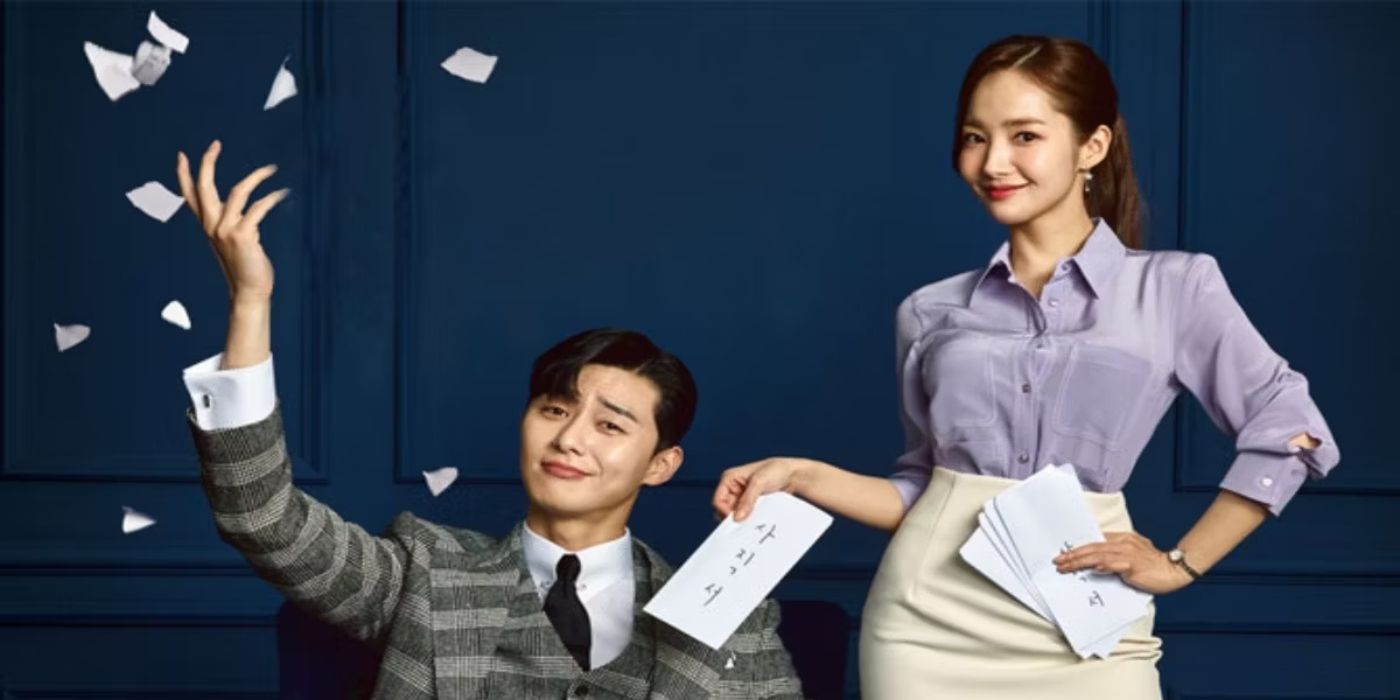 Park Seo-joon as Lee Young-joon and Park Min-young as Kim Mi-so sit on a sofa in dark suits for the poster for What's Wrong with Secretary Kim?