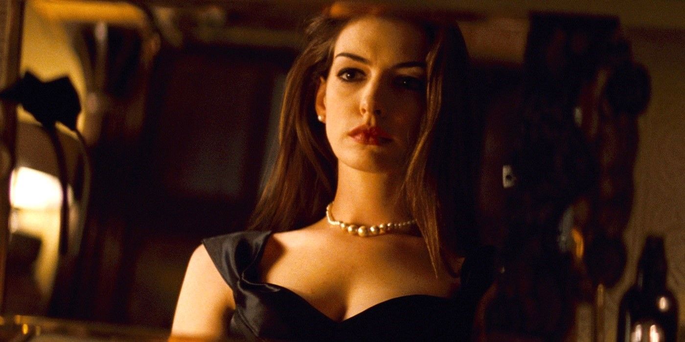 Anne Hathaway looking at herself in the mirror in The Dark Knight Rises.