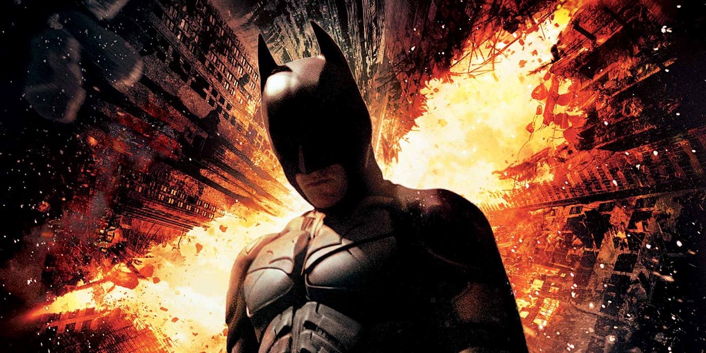 Batman with a burning city behind him in The Dark Knight Rises