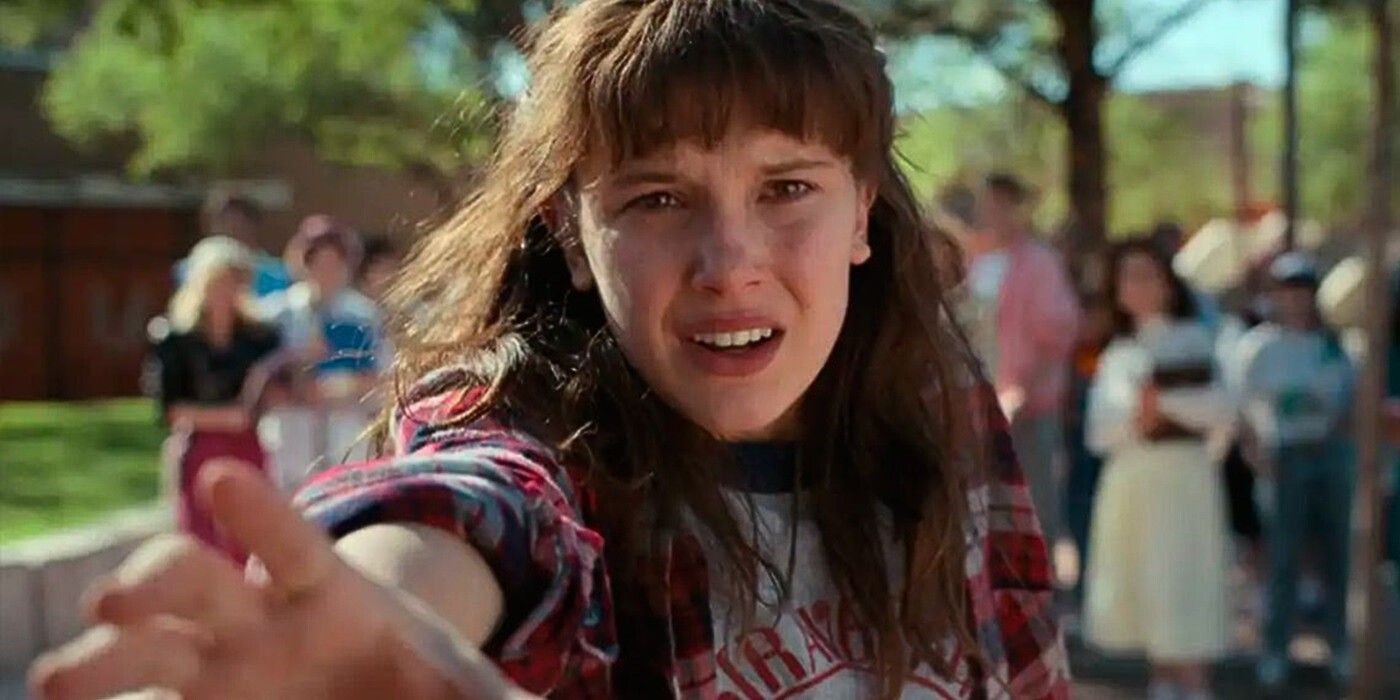 Millie Bobby Brown reaching out in Stranger Things.