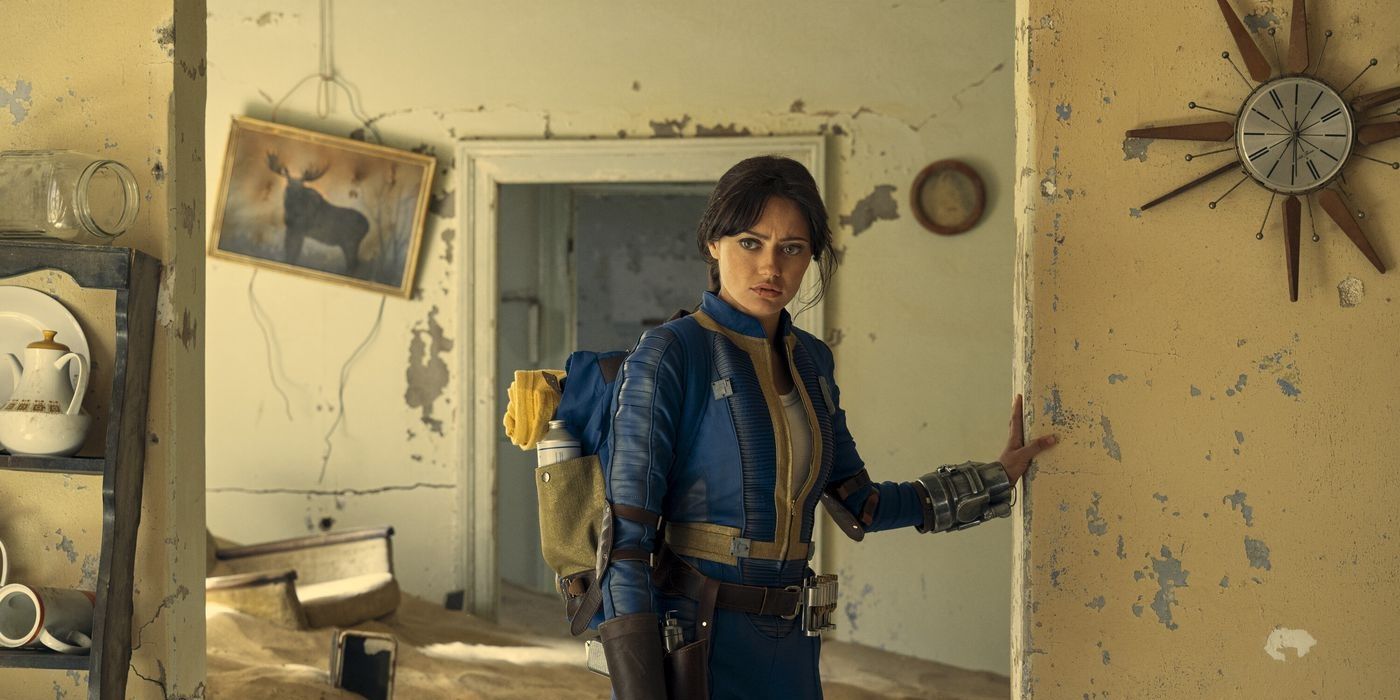 Ella Purnell as Lacy from Fallout wearing her Vault-Tex suit walking through an abandoned house