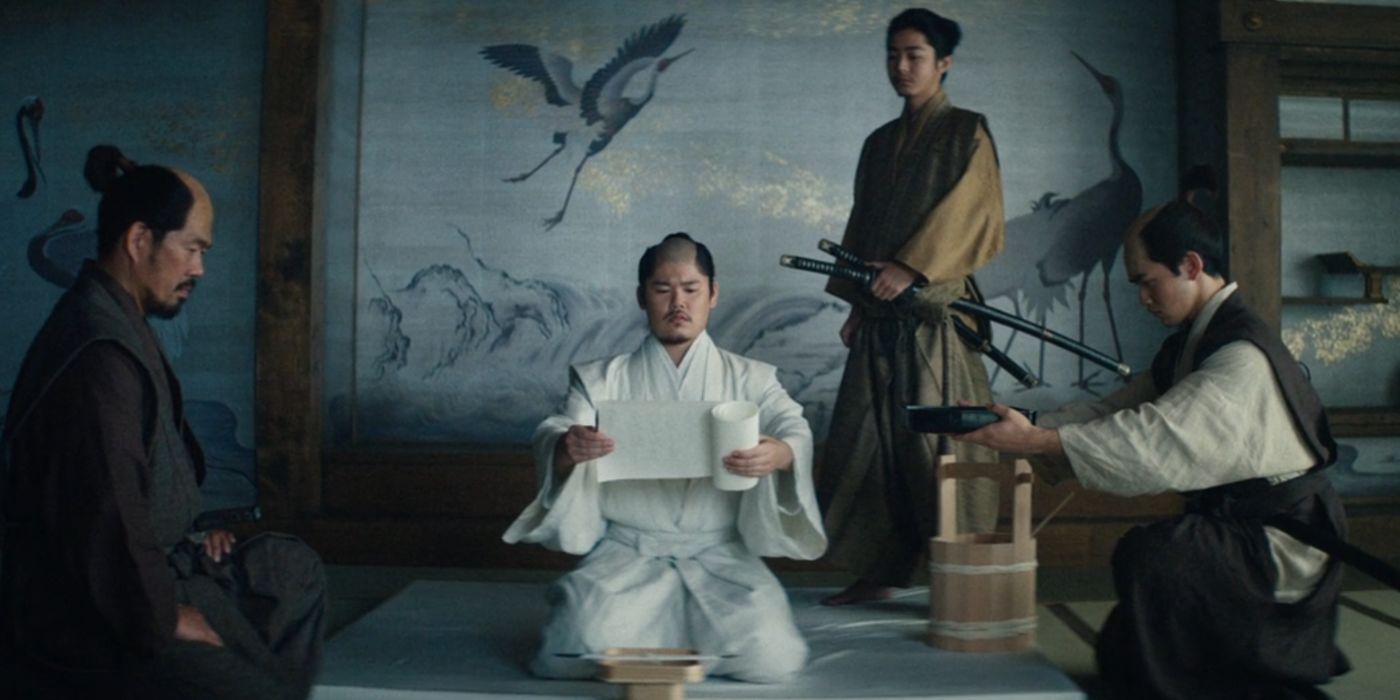 A man wearing all white kneeling down on the ground reading a scroll in Shogun