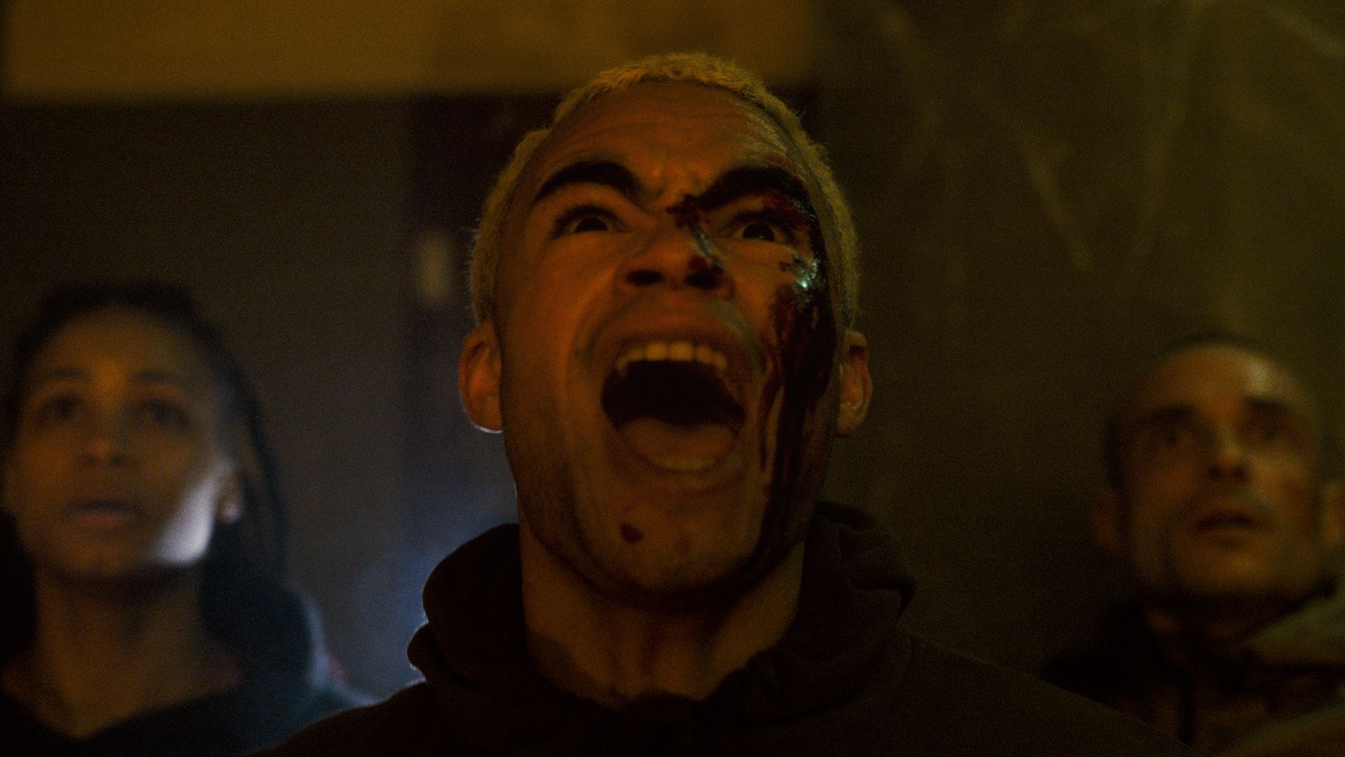 A close-up of Theo Christine as Kaleb in Infested, screaming in fear at something off-screen