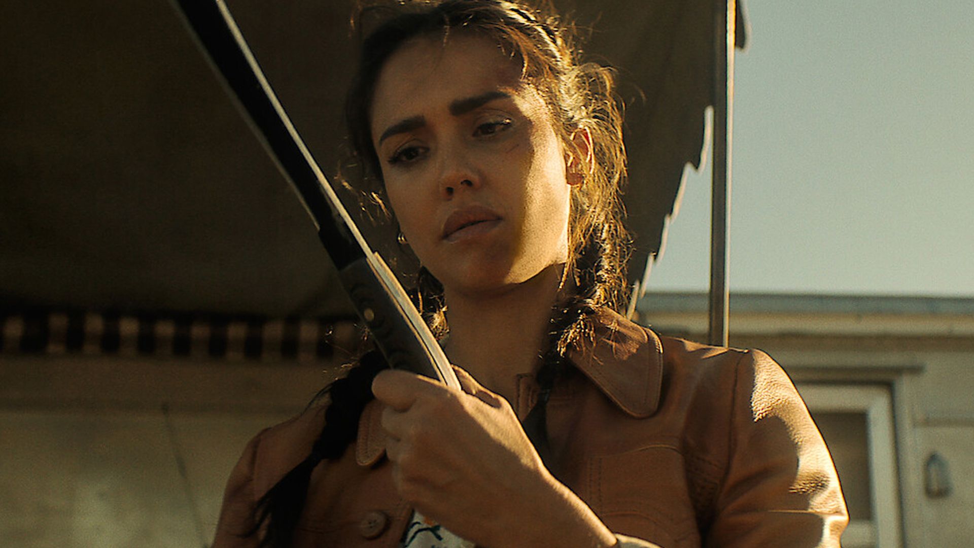 Jessica Alba examining a machete in Trigger Warning