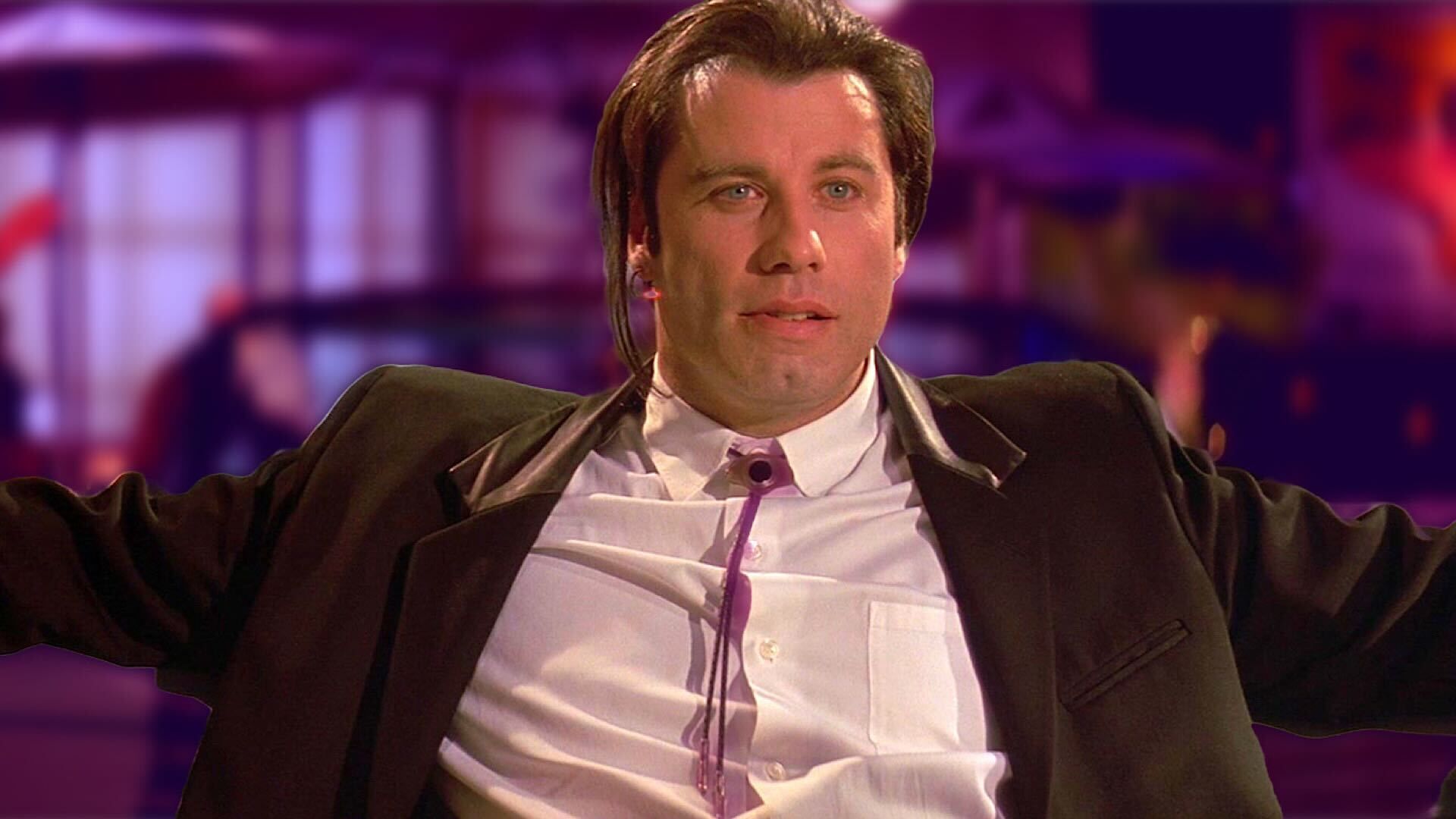 John Travolta leaning back in a chair in Pulp Fiction