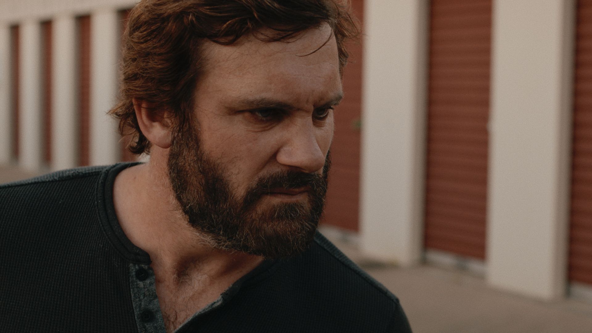 Clive Standen as Pete in Possessions looking angry while standing outside of a storage unit