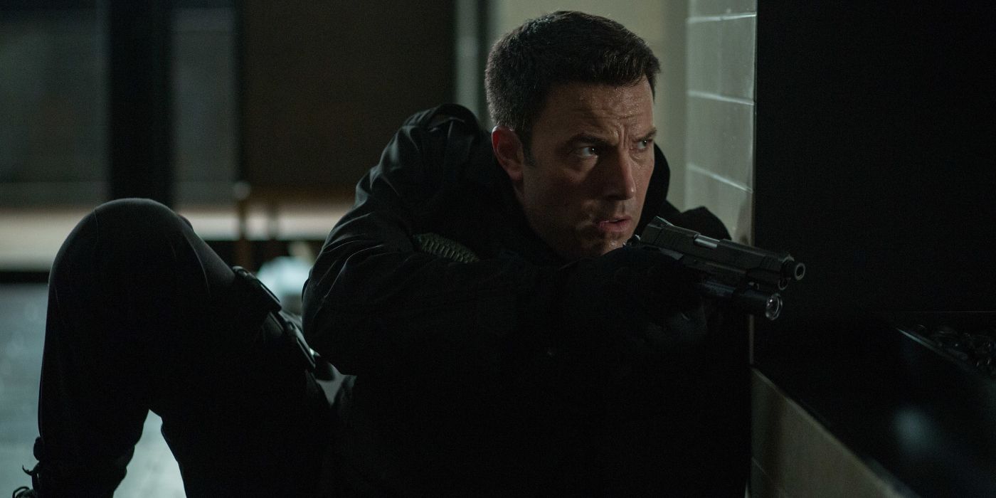 Chris takes cover with a gun in The Accountant