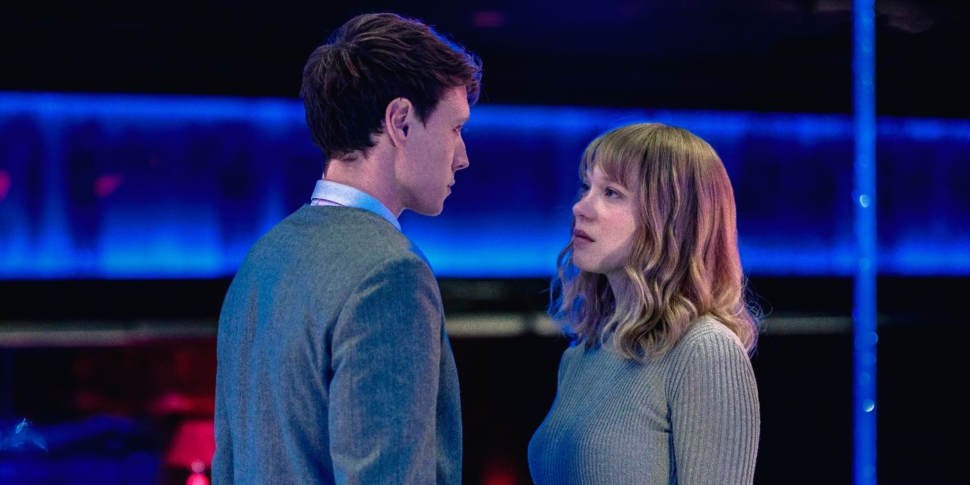 Lea Seydoux as Gabrielle and George MacKay as Louis, standing face-to-face in a neon-lit bar in The Beast