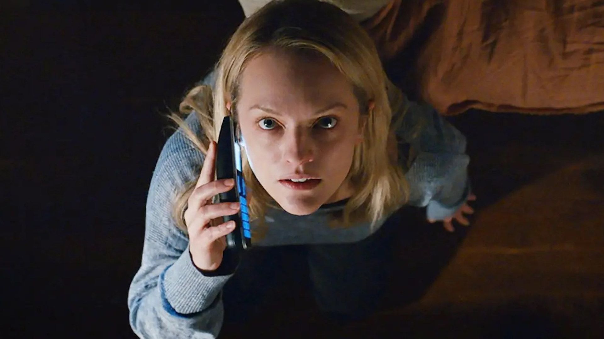 Elisabeth Moss in The Invisible Man talking on a phone and looking up.