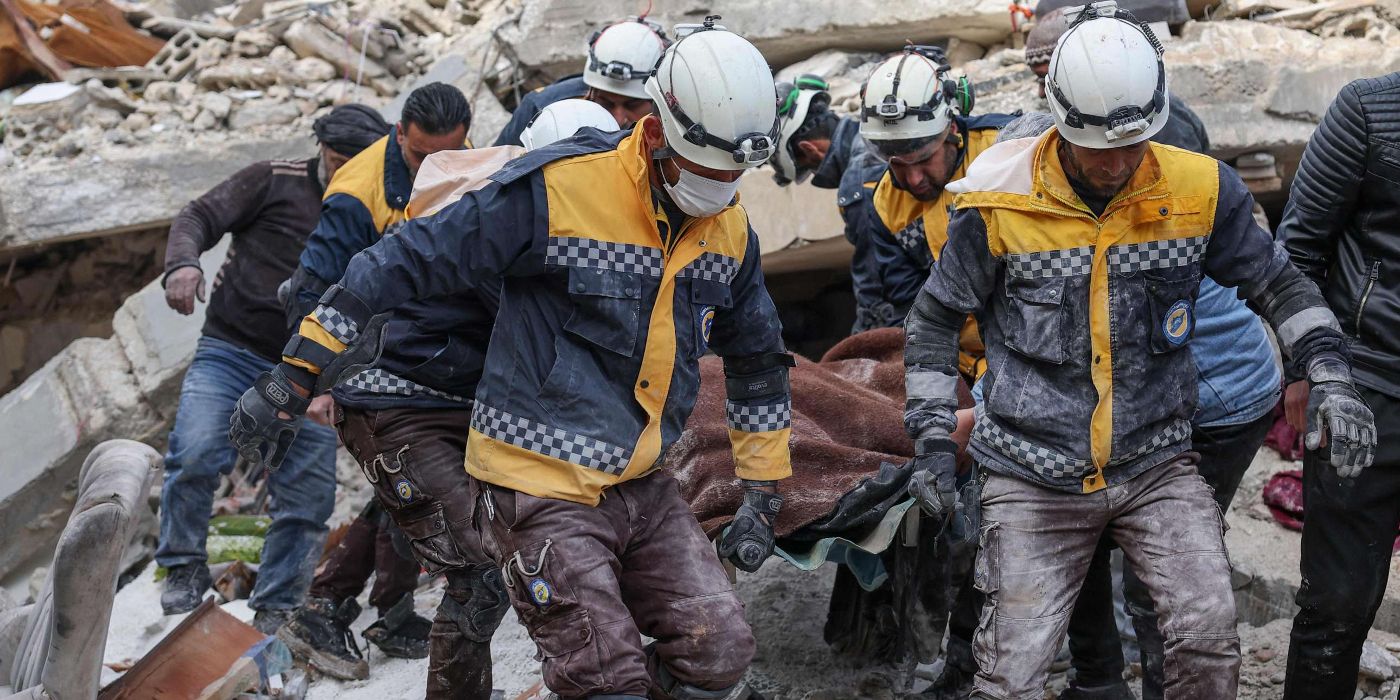Responders carry a stretcher in The White Helmets