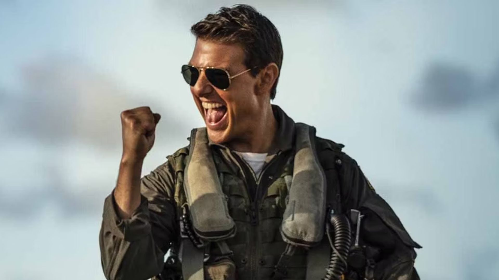 Tom Cruise as Pete Mitchell clenching his fist and smiling in Top Gun: Maverick